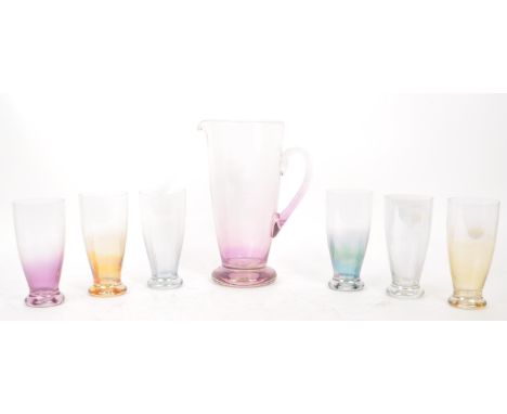 A vintage 20th century glass lemonade set. Comprising of a glass pitcher jug with a set of six high ball glasses of tapering 