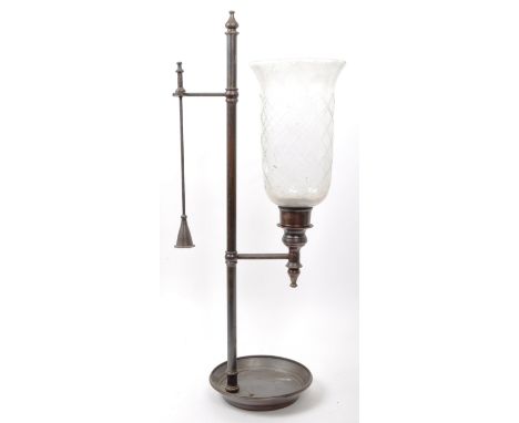 An early 20th century brass and glass pillar candle holder. Brass central support column with finial. Large cut glass shade a