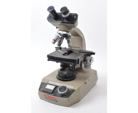 Vickers Instruments - A vintage 20th century Vickers Instruments microscope. Having knob and meter to front, with rotating le