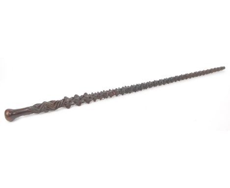 A vintage early 20th century hand carved wooden mahogany walking stick, featuring a carved spiked shaft, bulbous spherical ha