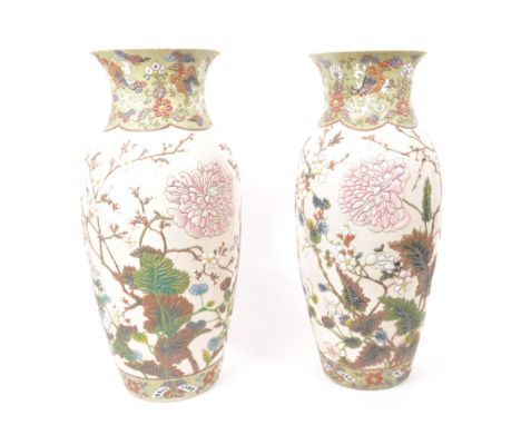 Two 20th century ceramic Chinese baluster vases, with enameled relief floral patterning to the bodies. Unsigned to the bases,