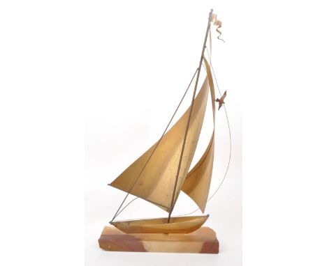 John Demott - A vintage mid century brass, copper and steel sailboat sculpture, mounted on an onyx base. Featuring two sails,