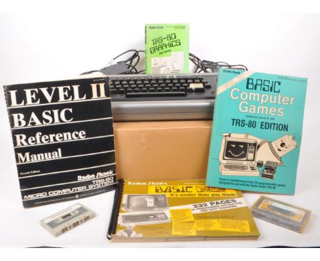 Radioshack - A vintage 20th century circa 1980s Radioshack TRS-80 microcomputer. The computer in original box, with basic ref