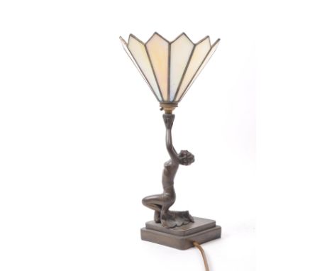 A vintage late 20th century Tiffany / Art Deco style brass lamp, featuring a lady dancer figure holding the petal-shaped crea
