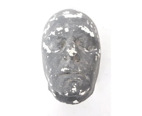 A vintage 20th-century macabre plaster death mask of an unknown man. Painted grey to the exterior. Measuring approx. 26cm x 1