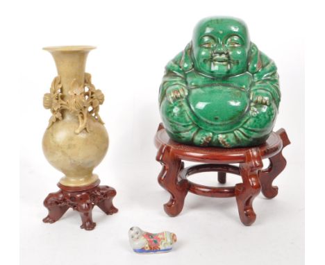 A collection of 20th century of Chinese Asian curious. Including glazed laughing Buddha, soapstone vase on Chinese hardwood b