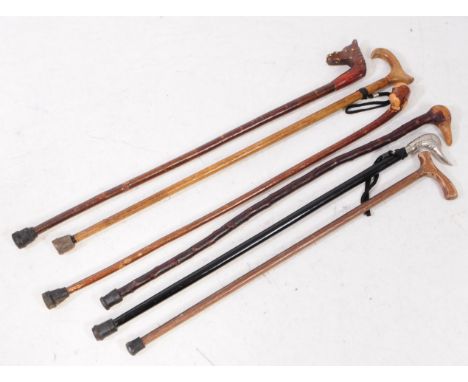 Collection of vintage 20th century hand made walking sticks / swagger canes. Including wooden horse head handle, driftwood kn