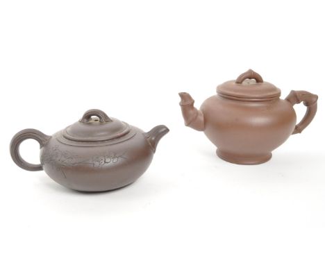 Two 20th Century Chinese ceramic teapots one squat example early 20th Century having engraved cherry blossom to body. Togethe
