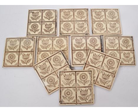 A collection of ten Victorian aesthetic period ceramic tiles, featuring brown and cream-coloured floral designs. Depicting fo