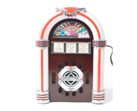 Steepletone - A 20th century model USB SUB LED miniature table top jukebox. With a wooden body, light up plastic detailing, i