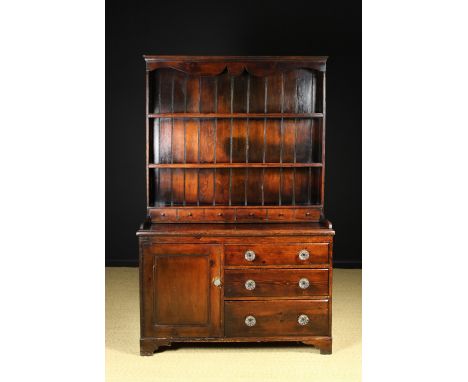 A Small Victorian Stained Pine Dresser. The rack having a moulded top over plank-backed shelves and a boxed in section of six