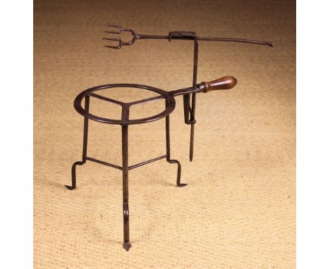 A 18th Century Steel Trivet Toaster with a sliding twin pronged fork rising up and down the loop ended stem above a trivet st
