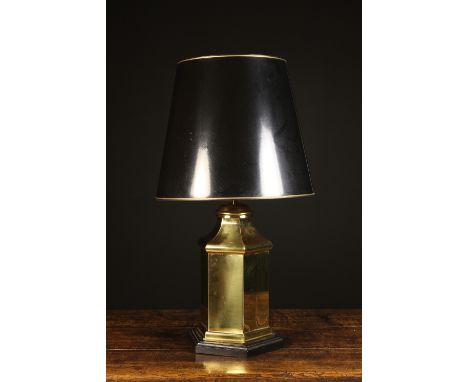 An Occasional Lamp. The black shade with gilt trim on a brass hexagonal stand with ebonised wooden base, 29 ins (74 cms) high