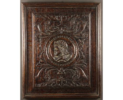 A 19th Century Carved Oak 'Romayne' Panel in the 16th century style. The framed panel centred by a profile portrait of a gent
