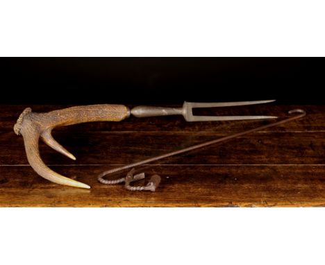 An Unusual 19th Century Scottish Venison Carving Fork with two steel tines and hinged guard mounted on an antler handle 31 in