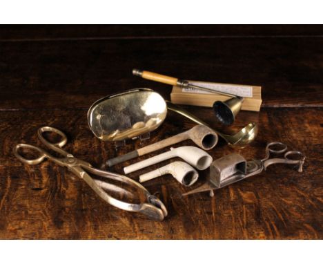 A 19th Century Oval Brass Tobacco Box with hinged lid, four pipes including a replica of a 16th century clay pipe, a steel sc
