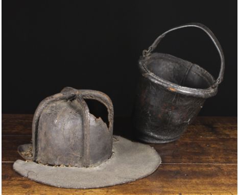 A 17th Century Leather Firemen's Helmet and a Leather Fire Bucket. The helmet 's crown composed of four stitched panels with 