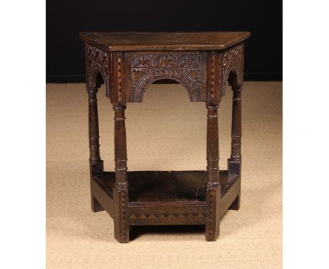 A 17th Century and Later English Carved & Inlaid Oak Credence/Side Table of canted form. The plain top above an arcaded apron