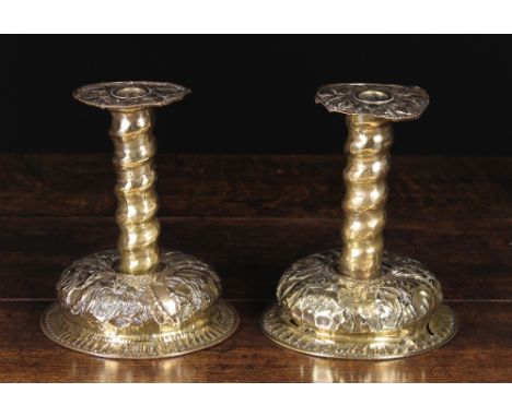 A Pair of Late 17th/Early 18th Century Scandinavian Sheet Brass Candlesticks enriched with repoussé decoration. The bobeches 