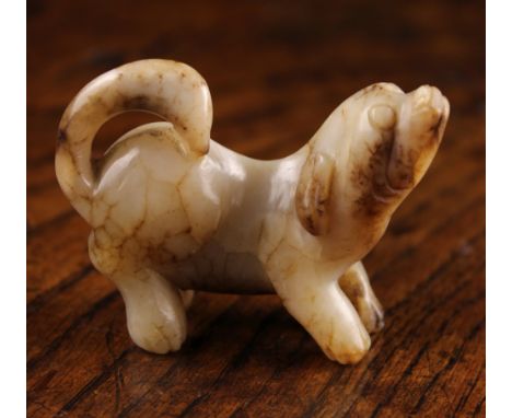 A 19th Century Chinese Jade Carving of a Dog, 2 ins (5 cms) high, 2½ ins (6.5 cms) in length.