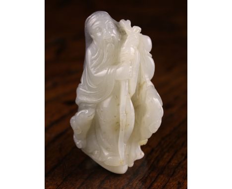 A 19th Century Chinese Bi-colour Jade Carving of a Sage carved from white stone with a ram at his feet sheltered beneath his 