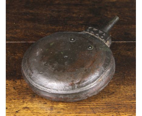 A 19th Century Leather Clad Afghan Jezail  Wooden Powder Flask. The flat-sided circular body with iron suspension loops and a