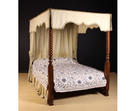 A William IV Style Four Poster Bed: The mahogany foot posts adorned with spiraling reeds and carved lotus-petal bulbs. The be