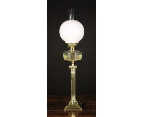 A Brass Oil Lamp having a reeded columnar stand with Corinthian style capital and stepped square plinth base, clear oil font 