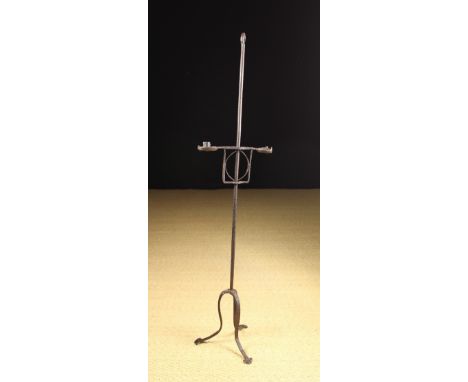 A 17th/Early 18th Century Wrought Iron Floor Standing Candle Light. The central stem with knopped finial and tripod base, hav