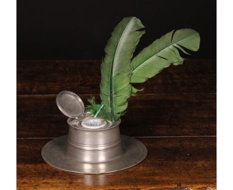 A 19th Century Pewter Capstan Inkwell with ring turned decoration, 7½ ins (19 cms) in diameter.* 