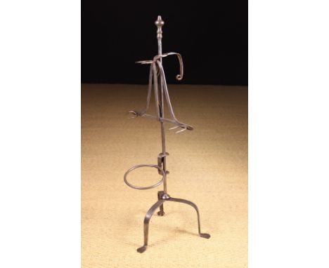 An 18th Century Steel Lark Spit or Standing Toaster. The central stem having a knopped finial and tripod base bearing a slidi