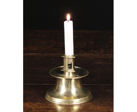A 16th Century Brass Capstan Candlestick having a flanged hexagonal socket pierced with round holes above lateral cut apertur