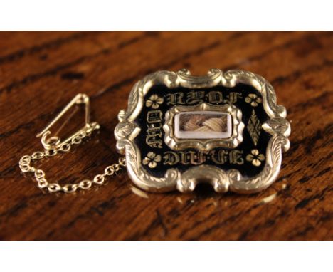 A 19th Century Unmarked Gold Mourning Brooch centred by a panel of braided hair in a verre eglomise surround, and inscribed o