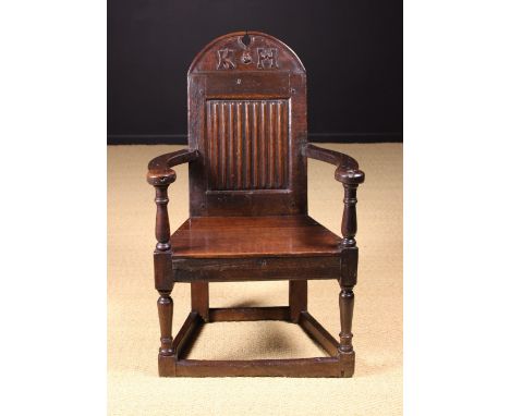 A Fine Mid 17th Century Joined Oak Caqueteuse Armchair of good, rich colour and patination.  The domed broken-arch cresting r