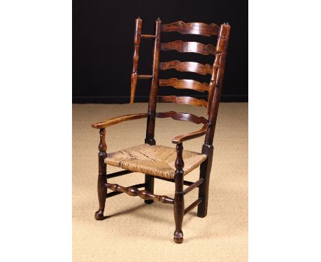 A Fine Late 18th/Early 19th Century Lancashire Wavy Ladder-back Winged Armchair with rush seat. The bowed back composed of si