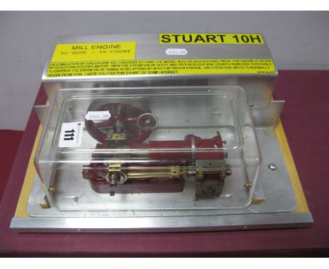 A Stuart 10H Horizontal Steam Engine, ¾ inch bore and stroke connected to a 3 inch flywheel, fitted with an electric motor an