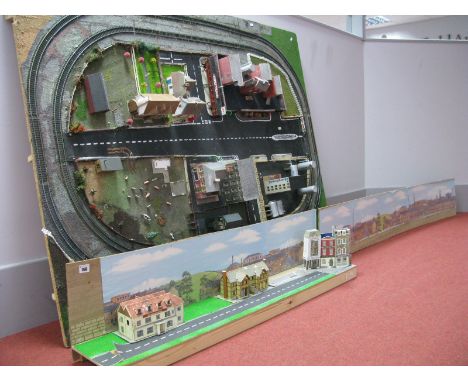 A "OO" Scale Model Railway Layout, made up of a double loop of track, with buildings, stations, scenery to centre with back d