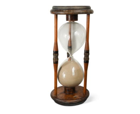 with turned ends and three ring-turned pillars enclosing a central glass timer 53cm high