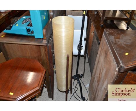 A retro teak standard lamp with plastic tubular shade