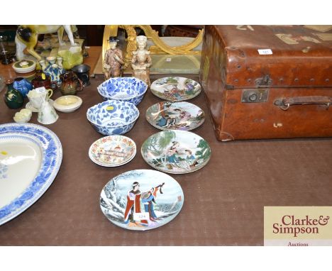 Various oriental wall plates; a pair of plaster figures; two blue and white oriental bowls and two saucer dishes with Eastern