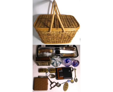 A picnic basket containing a cased carving set with horn handles, three glass paperweights, a small box inlaid with bone, a G