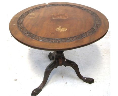 A 19th century mahogany occasional table, rounded top with foliate carved border above foliate carved tripod support, width 8
