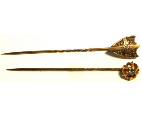 A 9ct gold stick pin with central white stone and one other yellow metal stick pin with shield shaped finial (2).