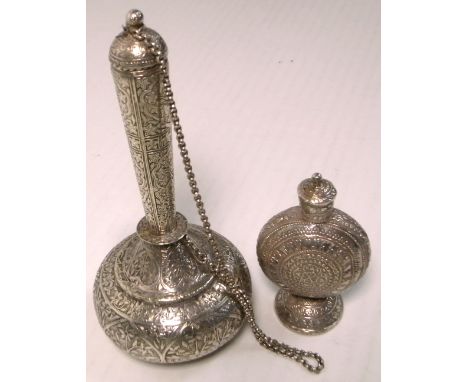 A white metal heavily engraved vase with cover, height 18cm and attached chain link and a white metal heavily engraved perfum