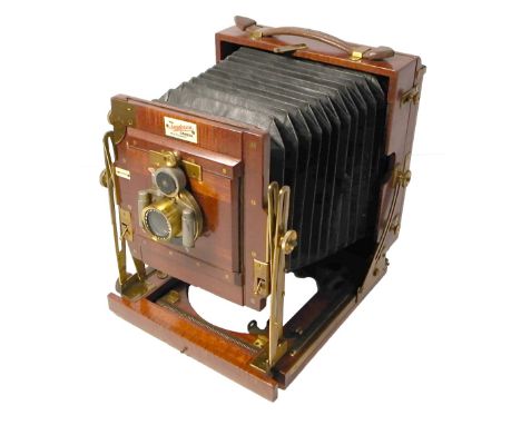 A Sanderson mahogany quarter plate field camera with brass fittings and complete with Beck symmetrical lens in automat shutte