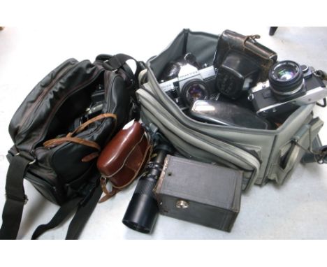 An Olympus OM10 35mm SLR camera with manual adaptor, a Praktica MTL5B, a Zenith 1980 Russian Olympic edition model EM, a Koda