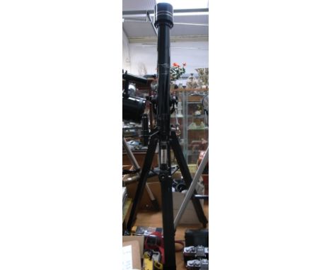 A Tasco 700mm astronomical telescope on tripod.