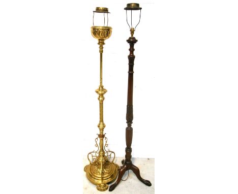 An ornate brass standard lamp with a stem of twist design to a rounded stepped base, height 172cm and a mahogany example with