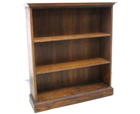 An early 20th century oak three shelf bookcase of simple form on a plinth base, width 100cm.