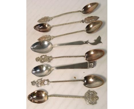 A cased set of six teaspoons with wrythen handles and various finials to include an Indian dancing girl, a sterling silver te